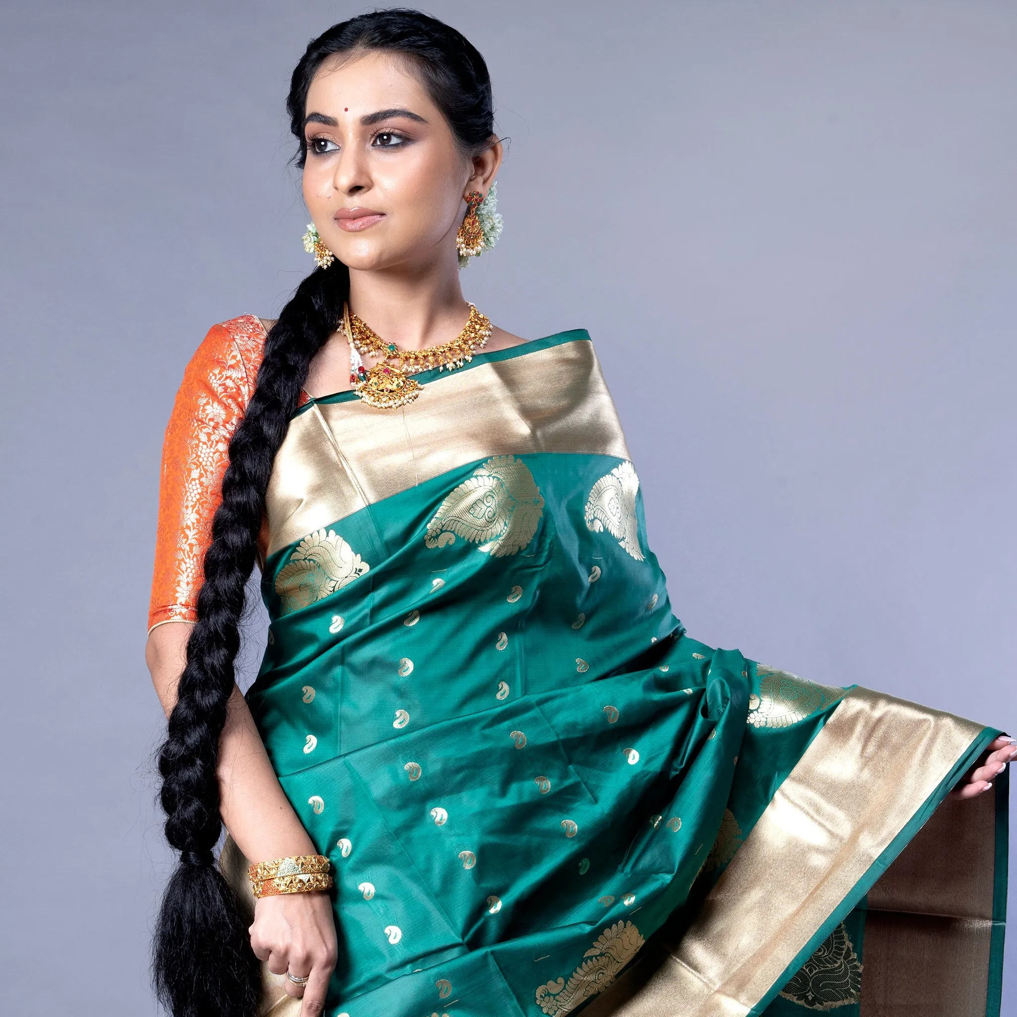 Women Kanjivaram Saree In Bottle Green Color With Golden Border And Booti