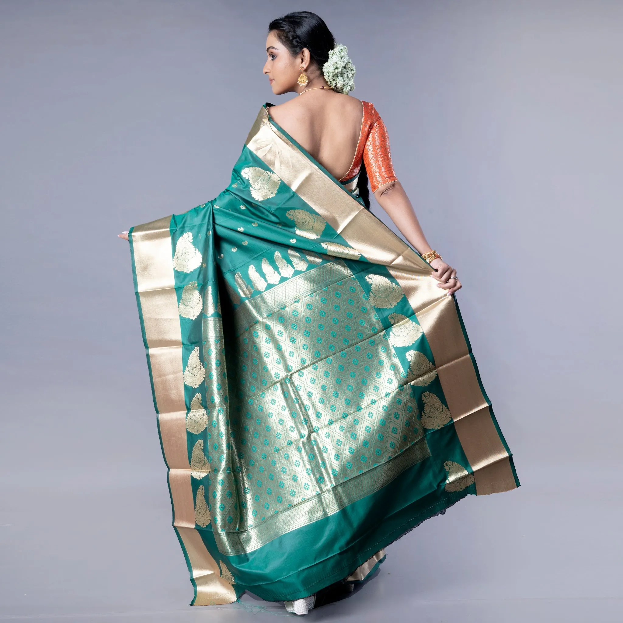 Women Kanjivaram Saree In Bottle Green Color With Golden Border And Booti