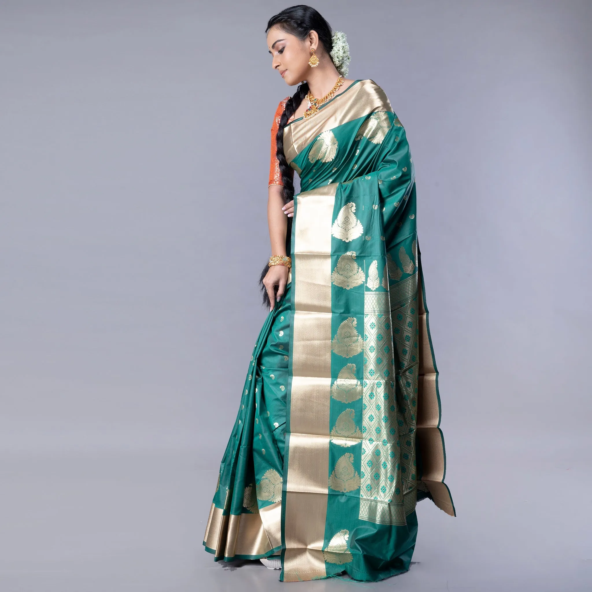 Women Kanjivaram Saree In Bottle Green Color With Golden Border And Booti